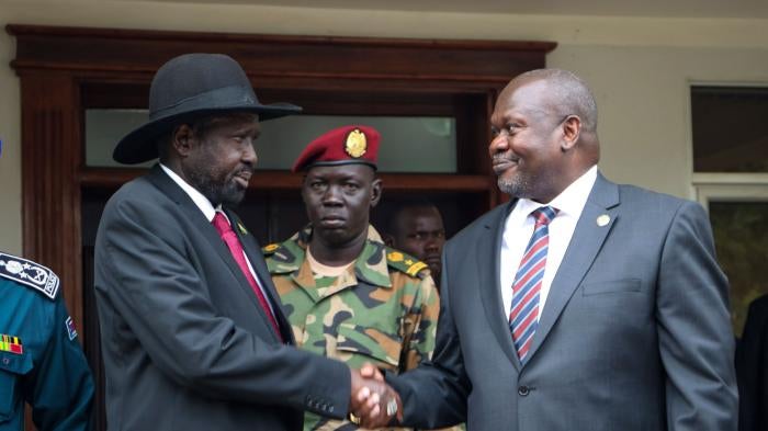 South Sudan's president Salva Kiir, left, and vice-president Riek Machar, right, shake hands
