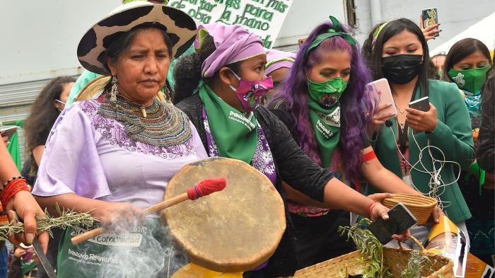 A group of women protesters playing drums