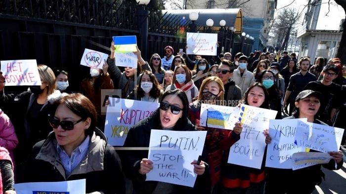 Demonstrators hold anti-war posters during an action against Russia’s attack on Ukraine near the Russian Embassy in Bishkek, Kyrgyzstan, February 28, 2022.
