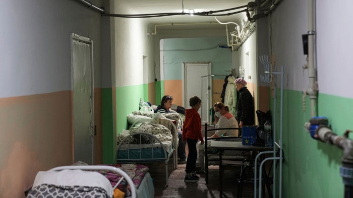 Women and their children sit in the basement of a maternity hospital converted into a medical ward and used as a bomb shelter in Mariupol, Ukraine