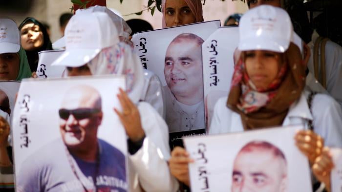 Palestinian demonstrators hold posters of Mohammad al-Halabi
