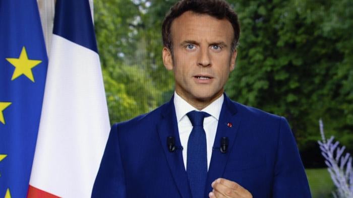 A photo of a TV screen shows French President Emmanuel Macron speaks during televised address on June 22, 2022, in Paris.