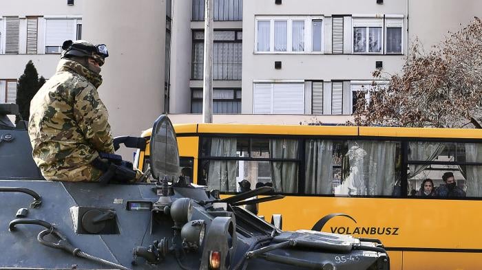 A troop rides in an armored personnel carrier