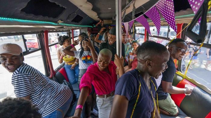 People on a bus among the thousands participating in the 30th Gay Pride event in Johannesburg, South Africa, October 26, 2019. ©2019 AP Photo/Jerome Delay
