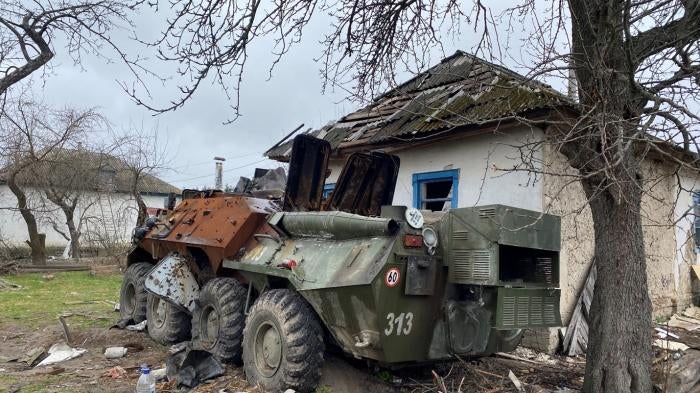 An abandoned Russian armored vehicle parked next to a home in Yahidne village, April 17, 2022. 