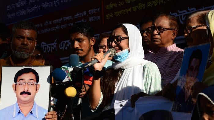 Relatives hold portraits of their missing family members during protest rally on behalf of victims of enforced disappearance by security forces, in front of National Press Club in Dhaka, Bangladesh, August 20, 2022.