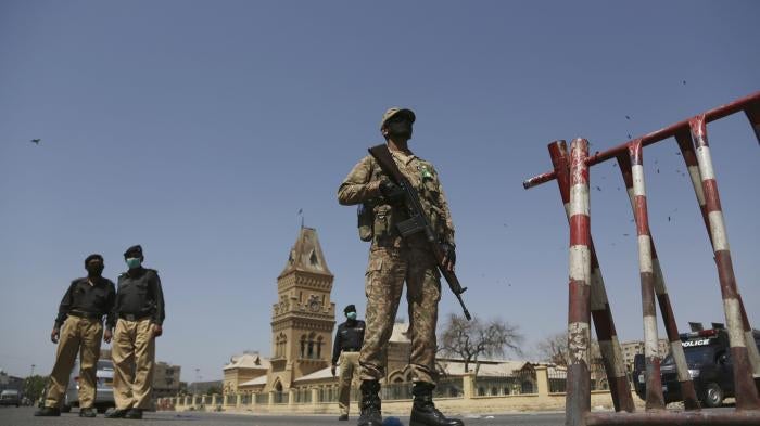 Soldiers and police stand guard during a lockdown to help stop the spread of the coronavirus, Karachi, Pakistan, March 3, 2020. 