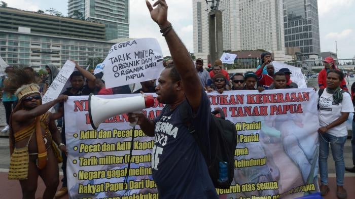 Papuan activists protest the killing of teenagers in Enarotali, at the Hotel Indonesia roundabout in Jakarta, December 10, 2014.