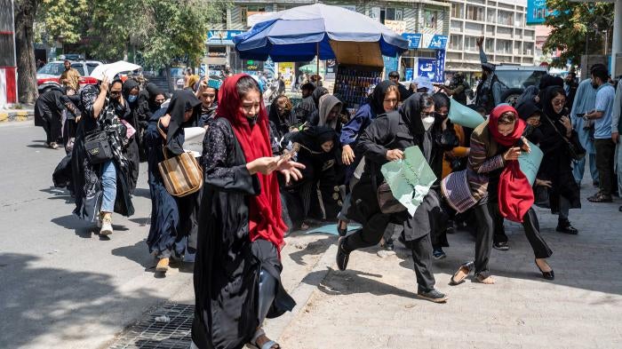 Taliban fighters fire into the air to disperse women protesters in Kabul, Afghanistan, August 13, 2022. © 2022/ AFP via Getty Images/Wakil Kohsar
