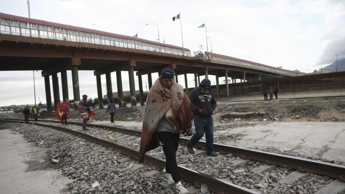 Venezuelans walk near a bridge that crosses the Rio Grande River after being expelled from the United States into Ciudad Juarez, Mexico, Tuesday, Oct. 18, 2022. The Biden administration announced on Oct. 12, that Venezuelans who cross the border irregularly will be immediately expelled to Mexico without being allowed to seek asylum.