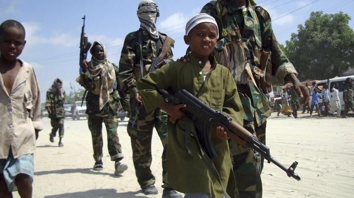 A young boy leads hard-line Islamist al-Shabab fighters in Mogadishu, Somalia. 