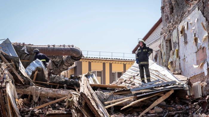 A fireman stands in the ruins of a building destroyed by a Russian cruise missile, which also injured several civilians, in Kharkiv, Ukraine, July 9, 2022.