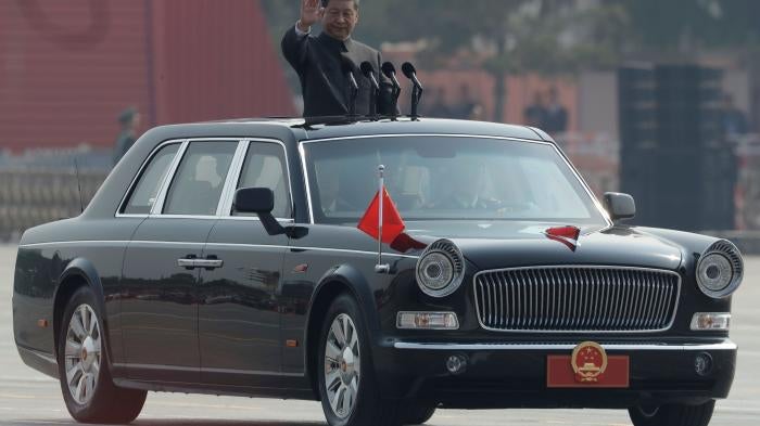 Chinese President Xi Jinping waving from a car