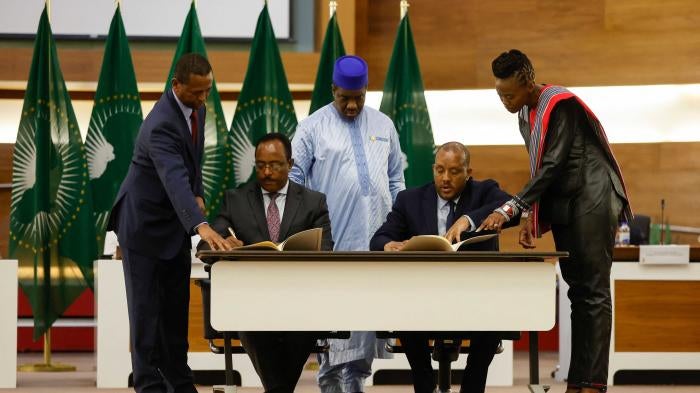 Redwan Hussein (2nd L), Representative of the Ethiopian government, and Getachew Reda (2nd R), Representative of the Tigray People's Liberation Front (TPLF), sign a “cessation of hostilities” agreement between the two parties after African Union-led negotiations, Pretoria, South Africa, November 2, 2022. 