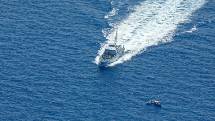 Libyan Coast Guard patrol boat Ras Jadir intercepts a wooden boat in the Mediterranean Sea, July 30, 2021. 