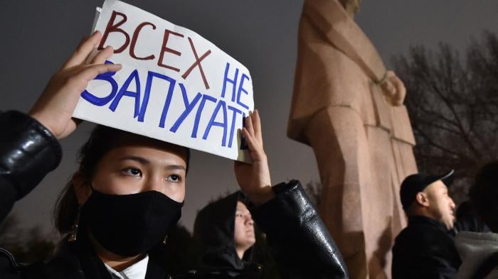 A protester holds a sign saying “don’t scare everyone” during a rally for freedom of speech and freedom for political prisoners in Bishkek, Kyrgyzstan on November 25, 2022. 