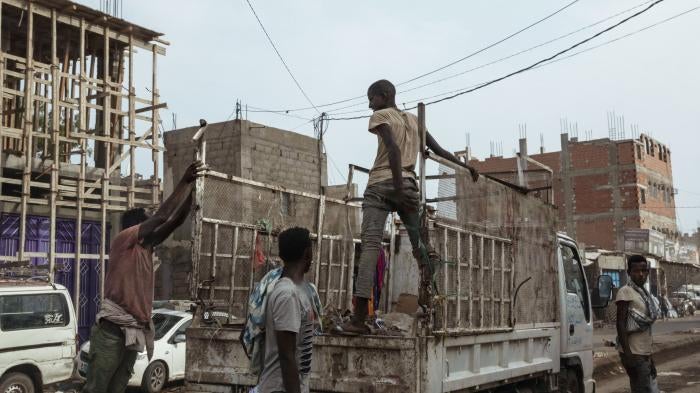 Ethiopian migrants climb on a pickup truck in Dhale province in Yemen.