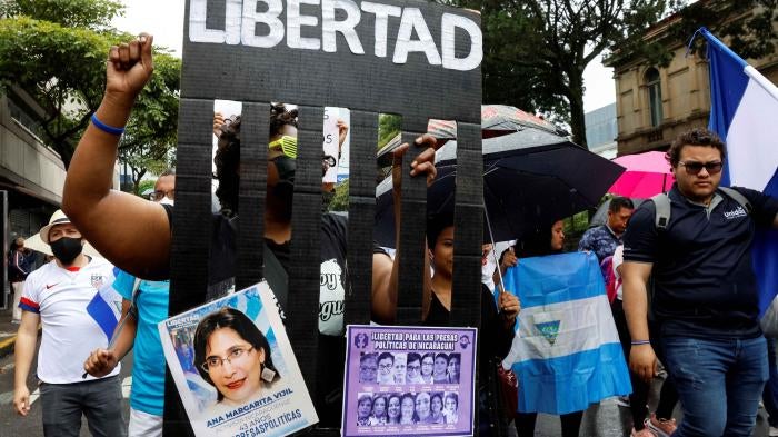 A demonstrator with a banner calling for the freedom of political prisoners in Nicaragua takes part of a march of Nicaraguans exiled in Costa Rica, in San Jose, Costa Rica, November 6, 2022.