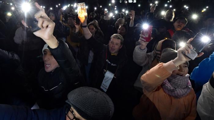 Protesters flash the light of their mobile phones during a rally for freedom of speech and freedom for political prisoners in Bishkek, Kyrgyzstan, on November 25, 2022. 