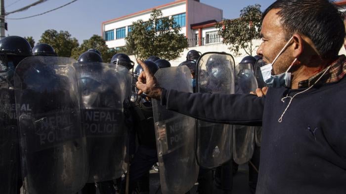 Nepalese youth clash with police as they protest outside Federal Parliament in Kathmandu, Nepal.