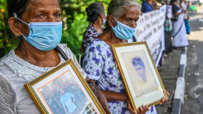 Women hold portraits of family members who went missing during Sri Lanka’s civil war that ended in 2009, during a demonstration in Colombo.
