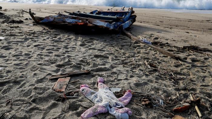 A piece of the boat and a piece of baby clothing from the deadly migrant shipwreck in Steccato di Cutro near Crotone, Italy