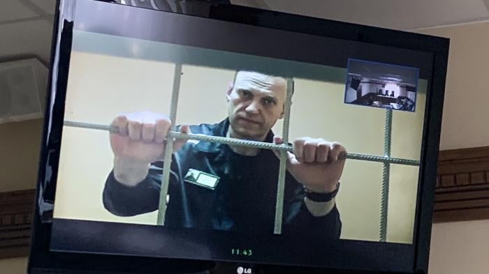 Russian opposition leader Alexei Navalny appears from prison on a video link in a courtroom in Vladimir, Russia. 