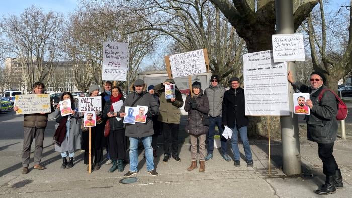 Supporters of Tajik activist Abdullohi Shamsiddin, in Dortmund, Germany, hold posters