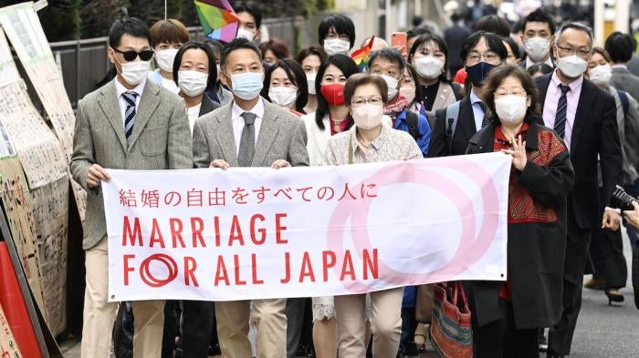 Plaintiffs and supporters of marriage equality for same sex couples walk to the Tokyo district court.