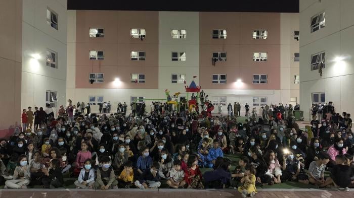 Afghans rally in an Afghan refugee camp in Abu Dhabi, the capital of the United Arab Emirates, to protest their non-transfer to the United States, February 13, 2022.