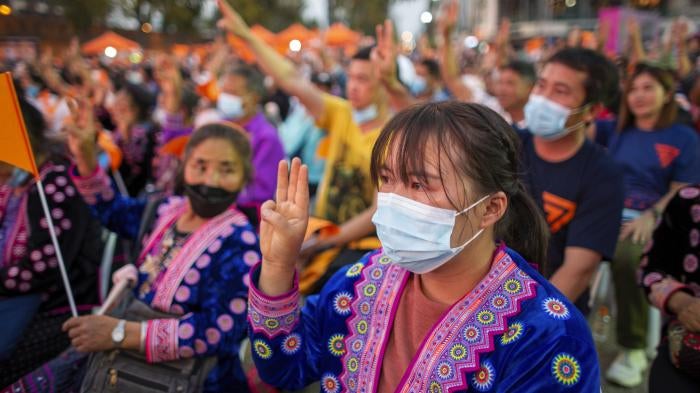 Ethnic minority women make three-finger salutes during pro-democracy demonstration in Chiang Mai, Thailand.
