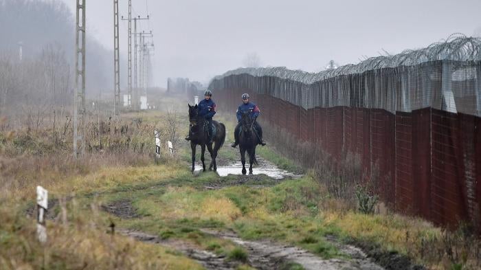 Police patrol the Hungarian-Serbian border barrier near Kelebia, Hungary, December 15, 2022. 
