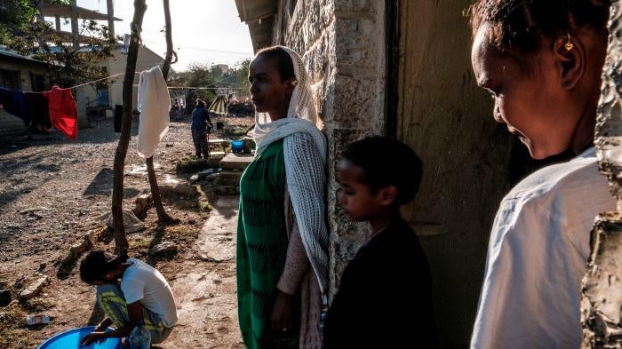Displaced people from Western Tigray stand outside a school where they are sheltering in Mekele, Ethiopia, February 24, 2021. 