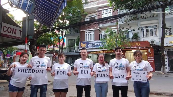 The wife, two brothers, and friends of Bui Tuan Lam gather in Da Nang city, Vietnam, to demand his freedom, May 2023.