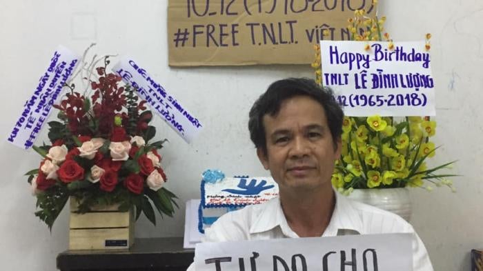 Tran Van Bang holds a sign that says “Freedom for Vietnamese Prisoners of Conscience” to celebrate the 70th anniversary of the Universal Declaration of Human Rights.