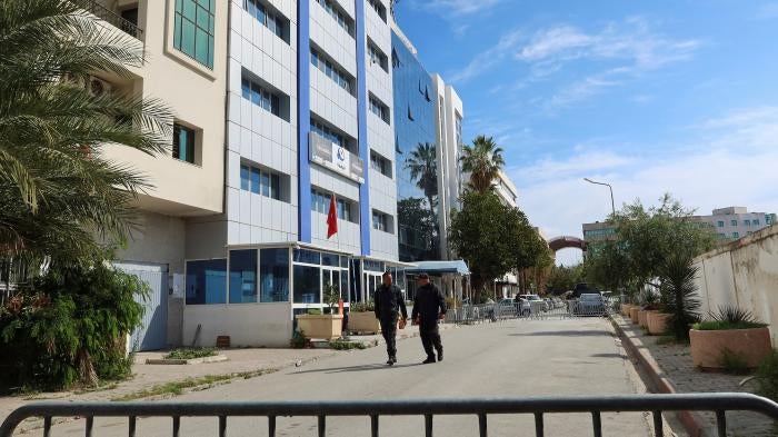 Police members walk outside the building of the Ennahda party headquarters, after police raided the headquarters and evacuated all present, Tunis, Tunisia.