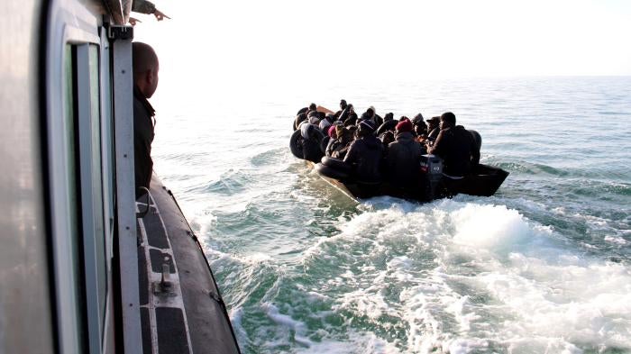 The Tunisian Maritime National Guard (coast guard) approaches a boat at sea carrying people from different African countries seeking to get to Italy, near the coast of Sfax, Tunisia, Tuesday, April 18, 2023. © 2023 AP Photo
