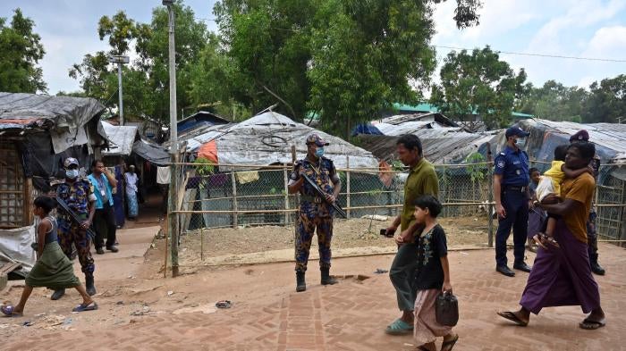 Security force officers stand guard after the killing of Rohingya community leader Mohib Ullah in the Kutupalong refugee camp, Bangladesh, October 2021.