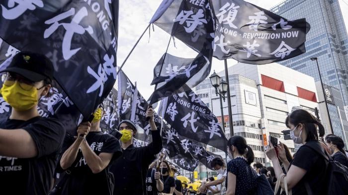 Pro-democracy demonstrators take to the streets in Shinjuku, Japan to mark the second anniversary of the anti-extradition bill movement in Hong Kong, June 12, 2021. 