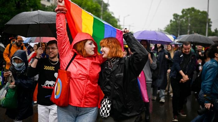 Participants hold a LGBTQI flag as they take part in the annual Gay Pride Parade in downtown Sofia, Bulgaria on June 17, 2023.