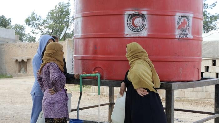  Residents of al-Hasakeh city gather around a communal water tank to fill up Jerry cans and buckets with water for their daily needs as they hardly get any water from the city’s water network due to longstanding water disputes, al-Hasakeh city, northeast Syria, May 8, 2023.