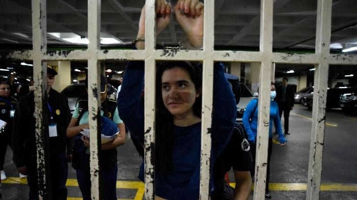 Marcela Blanco (C), a member of the Semilla Party, arrives handcuffed for a hearing at the Palace of Justice after being arrested at her home in Guatemala City on November 16, 2023.