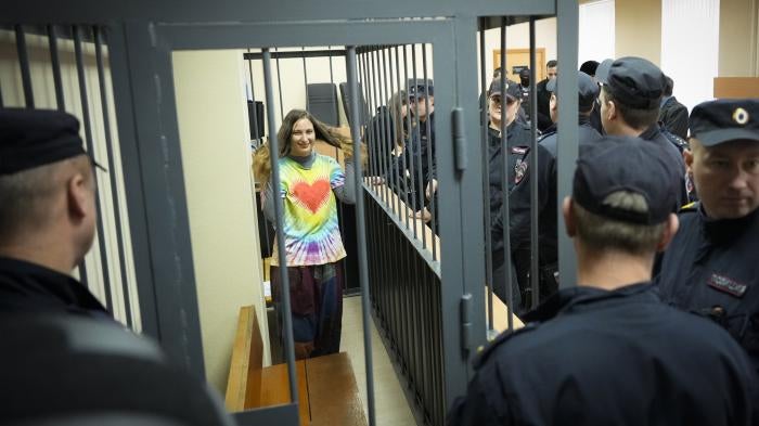 Sasha Skochilenko stands behind bars in the court room at the Vasileostrovsky district court in St. Petersburg, Russia, November 16, 2023.