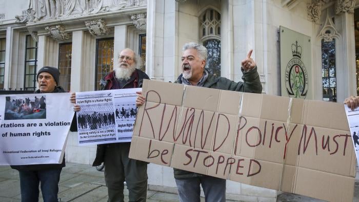 Protesters hold placards outside the UK’s Supreme Court as it rules that the UK Government's Rwanda asylum plan is unlawful, London, United Kingdom, November 15, 2023.