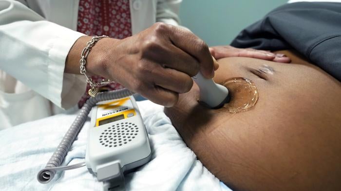 A doctor examines a pregnant woman to measure the heartbeat of the fetus, Jackson, Mississippi, US, December 17, 2021. 