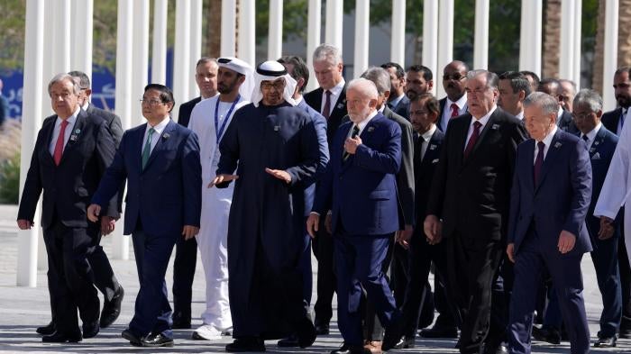 United Nations Secretary-General Antonio Guterres, left, and Brazil President Luiz Inacio Lula da Silva, center, walk with other dignitaries after posing for a group photo at the COP28 U.N. Climate Summit in Dubai, United Arab Emirates, December 1, 2023.