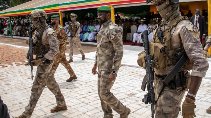 The leader of Mali’s junta, Lt. Col. Assimi Goita, center, attends an independence day military parade on September 22, 2022, in Bamako, Mali. 