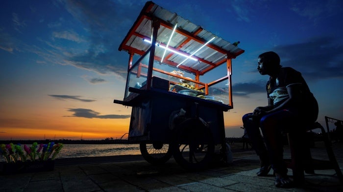A street food vendor awaits customers at the Galle Face promenade in Colombo, Sri Lanka, April 9, 2023. 
