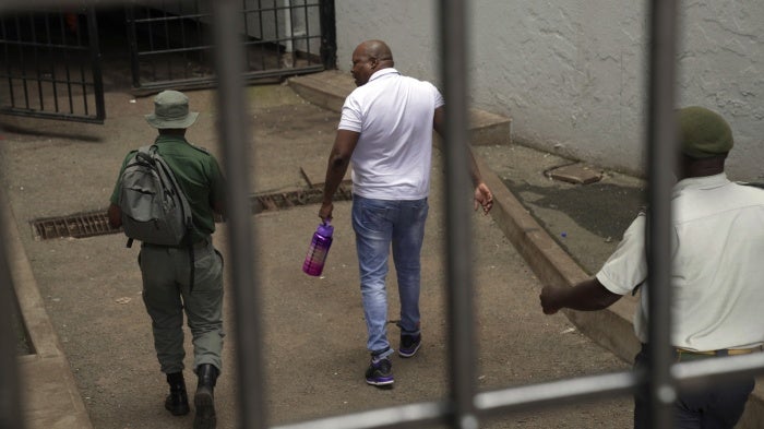 Zimbabwean opposition politician Job Sikhala enters the holding cells at the magistrates court in Harare, Zimbabwe