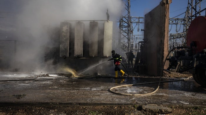 Syrian Kurdish firemen put out a blaze at a power station in Qamishli which was reportedly targeted by Turkish drones on January 15, 2024. 